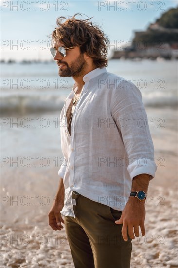 Summer lifestyle with a young dark-haired Caucasian man with long beard