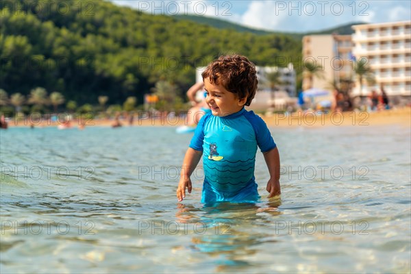 A little boy enjoying the summer on the beaches of Ibiza on holiday at San Vicente beach