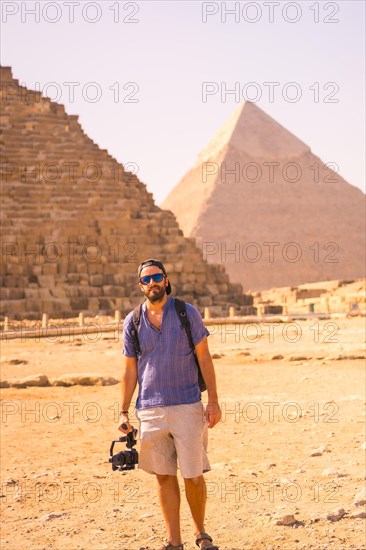 A young photographer at the pyramid of Cheops the largest pyramid. The pyramids of Giza the oldest funerary monument in the world. In the city of Cairo