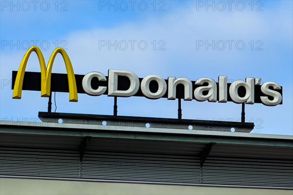 Logo yellow M in with lettering McDonald's above fast food restaurant