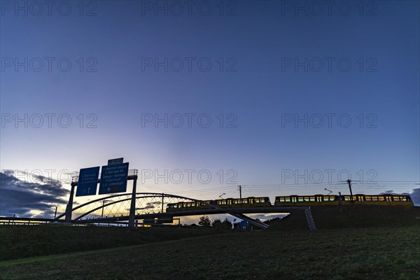 Network arch bridge over the A8 motorway. Light rail bridge of the SSB for the U6 airport line. The span of the arches is 80 metres. Tension elements made of carbon. The U6 line light rail bridge rece...