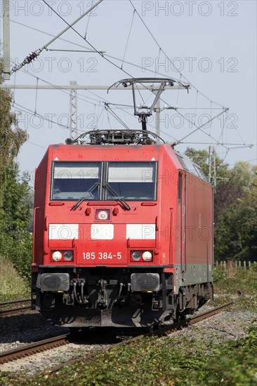 Red locomotive class 185 on a railway track