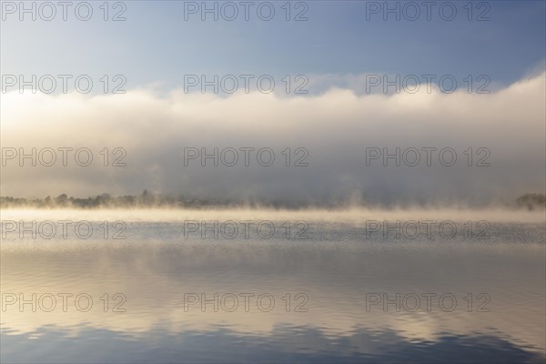 Fog over Lake Constance on an autumn morning with boats