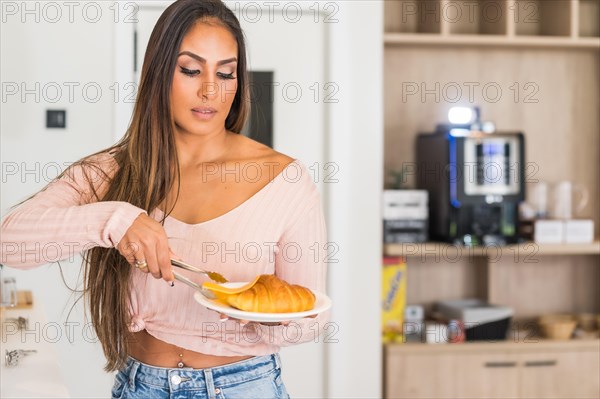 Casual business woman picking up pastries in a breakfast buffet in an hotel