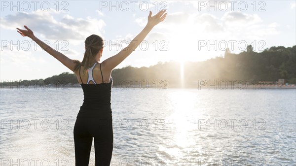 Back view woman enjoying sun light