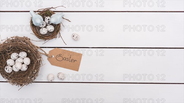Easter inscription with quail eggs nests