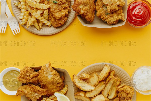 Flat lay fish chips with copy space sauces