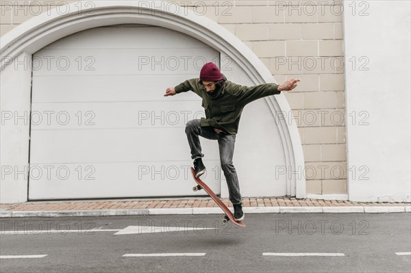 Man outdoors with skateboard city