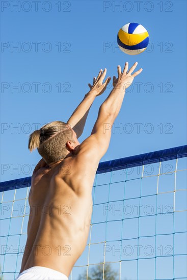 Man preparing hit incoming volleyball net
