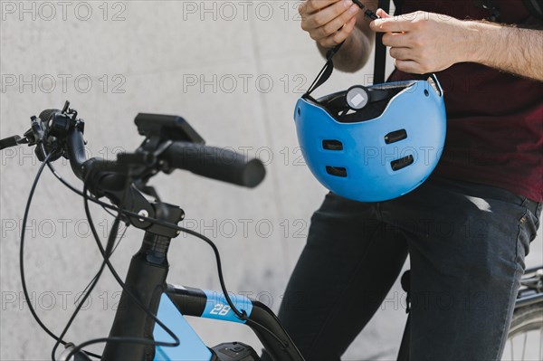 Close up man holding helmet bicycle
