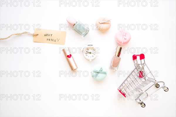 Shopping trolley with little alarm clock macaroons sale tag lipstick nail polish
