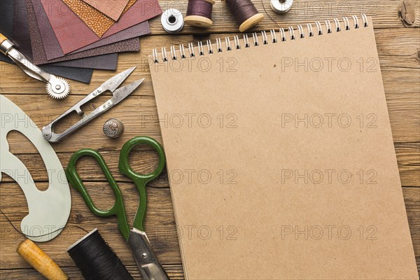 Top view notebook with scissors leather