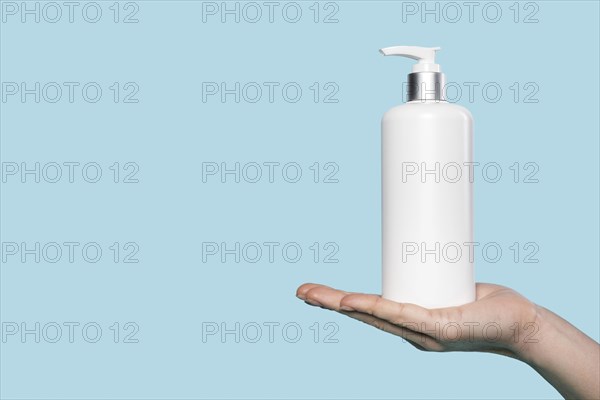 Woman holding liquid soap bottle