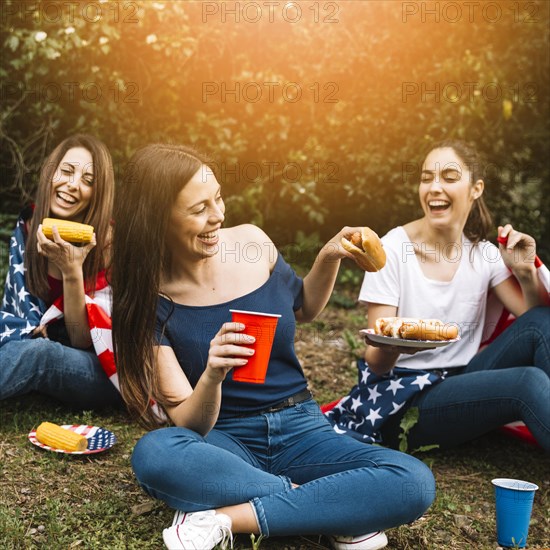 Women sharing hot dogs