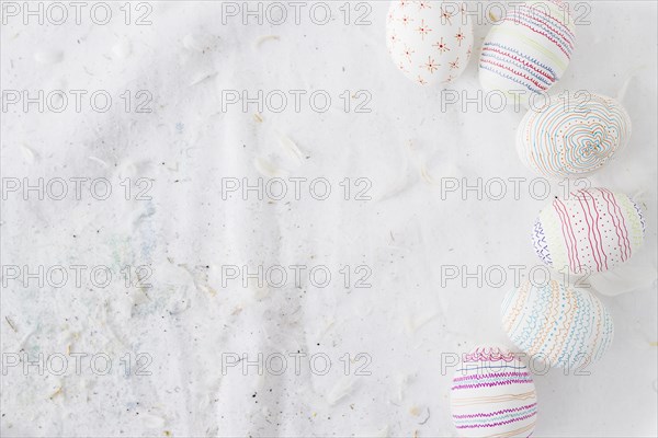Collection easter eggs with patterns near quills textile