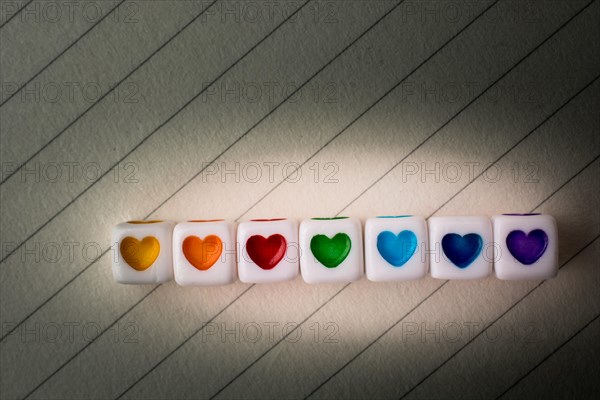 Colorful cubes with a heart placed on paper