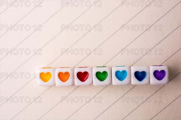 Colorful cubes with a heart placed on paper