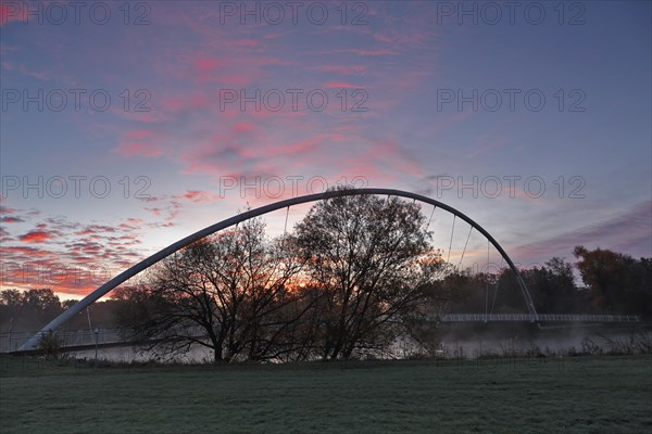 Bridge over the river Mulde near Dessau-Rosslau in the morning with atmospheric cloudy sky