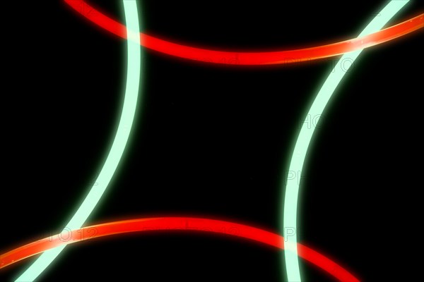 Illuminated red green curve lights black background