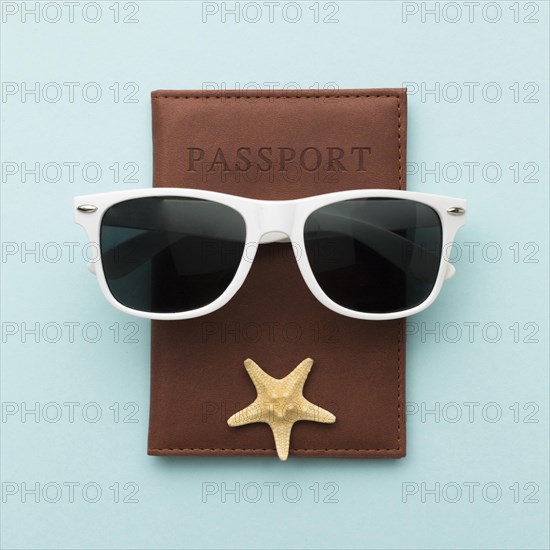 Top view summer glasses with passport