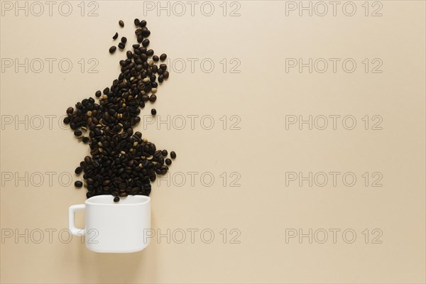 Cup with coffee beans copy space