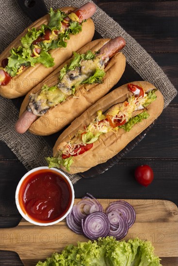 Top view three hot dogs with ketchup onions