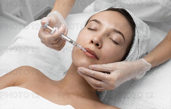 Beautician doing injection filler female client 8