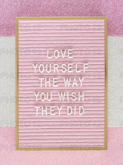 Pink motivational text board top view