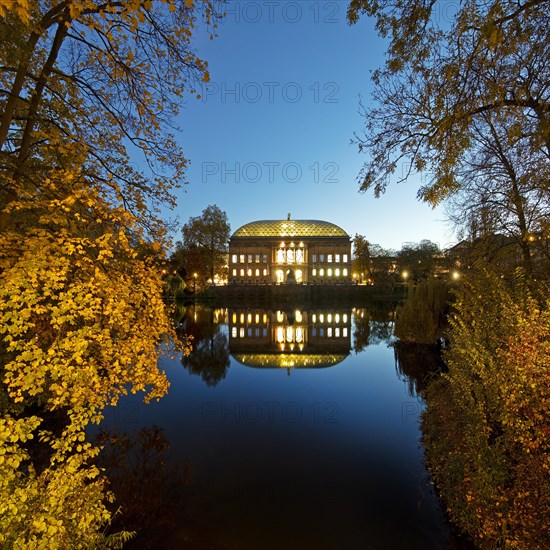 The Staendehaus K21 is reflected in the Kaiserteich in autumn in the evening