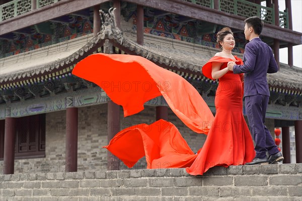 Wedding couple standing on the city wall in Xian
