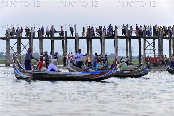 Locals and tourists on a teak bridge