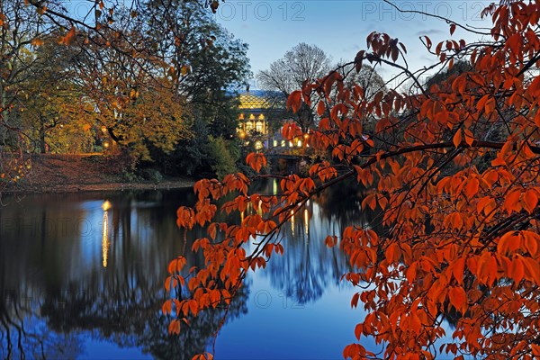 The Staendehaus K21 is reflected in the Kaiserteich in autumn in the evening
