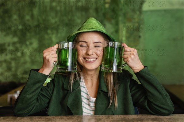 Front view smiley woman with hat celebrating st patrick s day bar