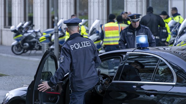 Police with yellow high-visibility waistcoats