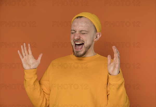 Happy young man laughing indoors 6