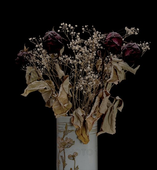Dried bouquet of roses in a vase