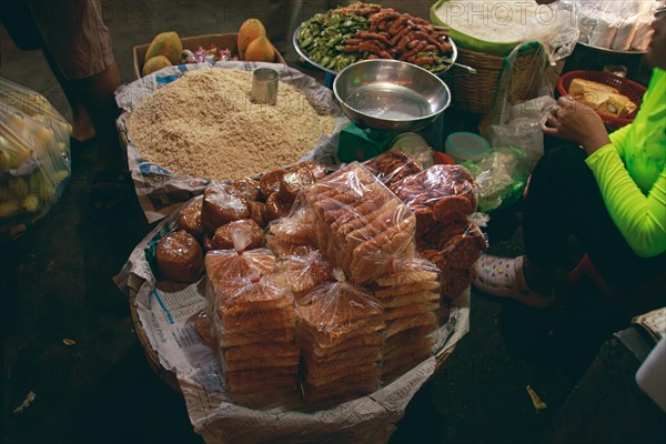 Authentic local khmer desserts sold in the traditional Samaki Market in Kampot Cambodia showing the candid daily life