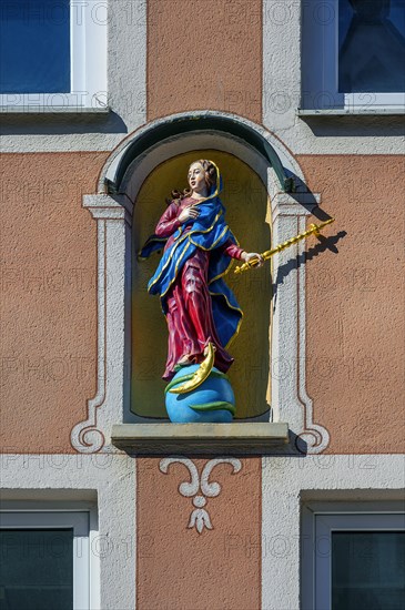 Facade with Madonna figure on globe with moon and snake