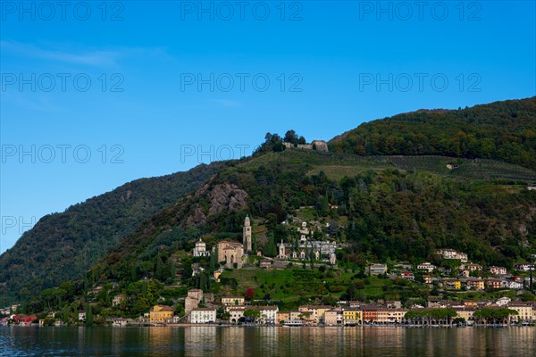 Beautiful Village Morcote witha Chucrh and Castle on Lake Lugano and Mountainscape with blue Clear sky in Morcote