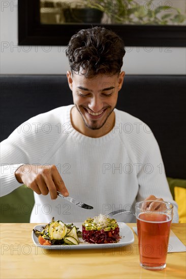 Medium shot man eating vegetarian food