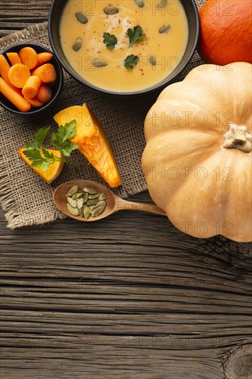 Flat lay pumpkin soup carrots pumpkin with copy space