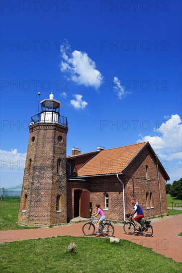 Cyclist in front of the lighthouse at the Cape of Vente