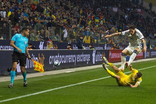 Vitaly MYKOLENKO Ukraine clears in front of Nicolo' ZANIOLO Italy in front of the linesman