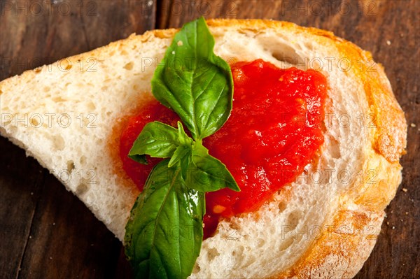 Italian fresh tomato and basil bruschetta with pecorino cheese over old wood