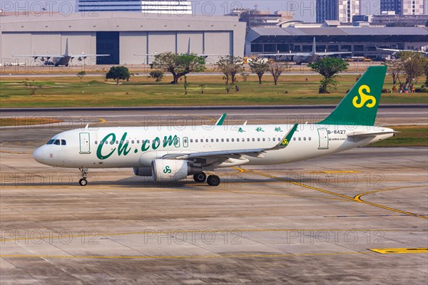 A Spring Airlines Airbus A320 aircraft with registration number B-8427 at Bangkok Don Mueang Airport