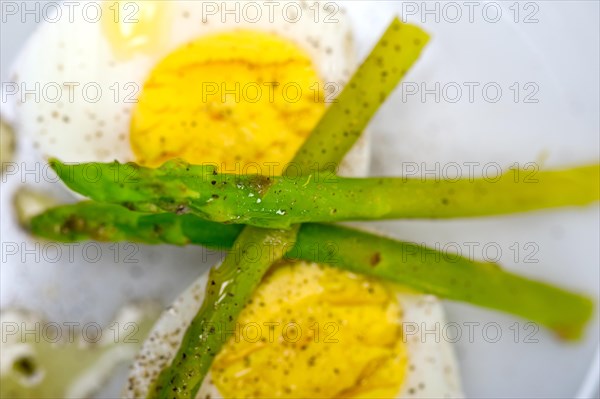 Boiled fresh green asparagus and eggs with extra virgin olive oil