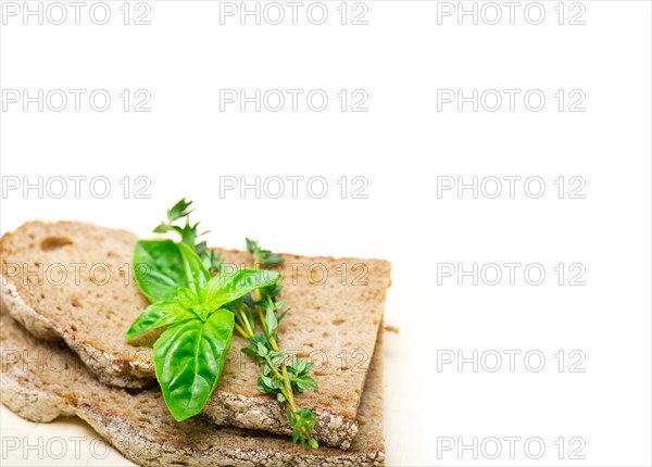 Rustic Italian bread basil and thyme simple snack on white wood table