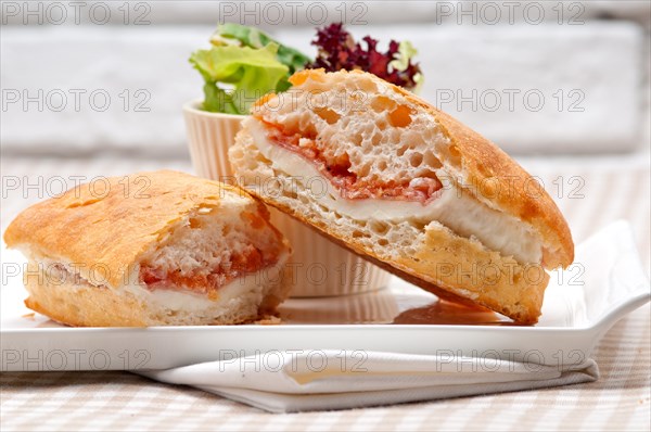 Italian ciabatta panini sandwich with parma ham and tomato