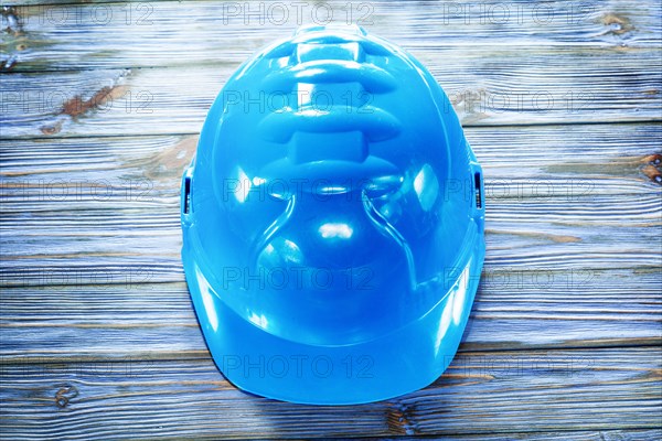 Blue building helmet on vintage wooden board