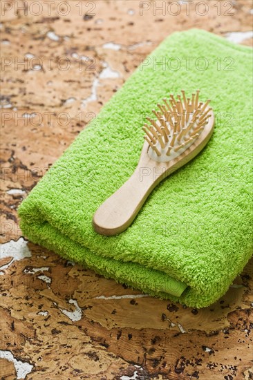 Towel and hairbrush on cork wood